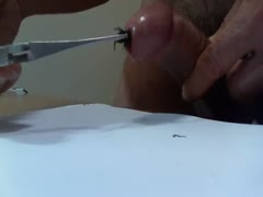 In this film, a bold dilettante man pushes a metal weenie down the shaft of his firm cock.